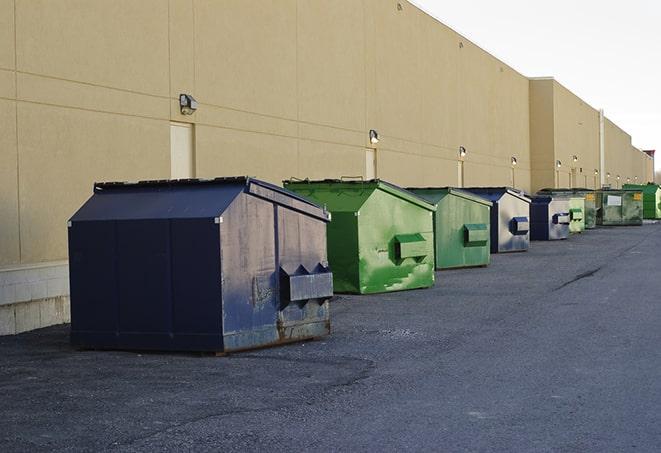 a construction worker moves construction materials near a dumpster in Brillion WI